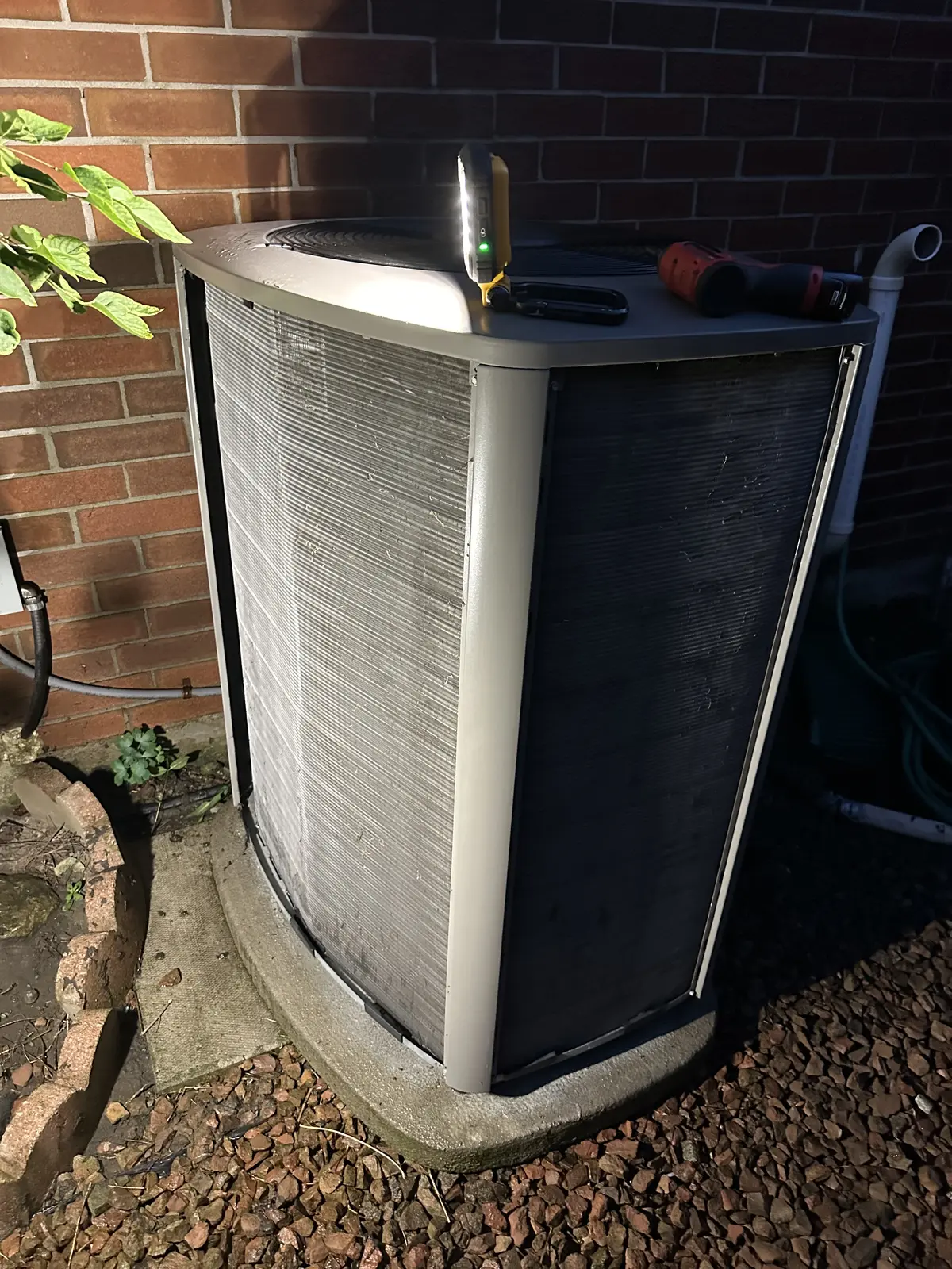 Outdoor AC condenser with panels removed during service